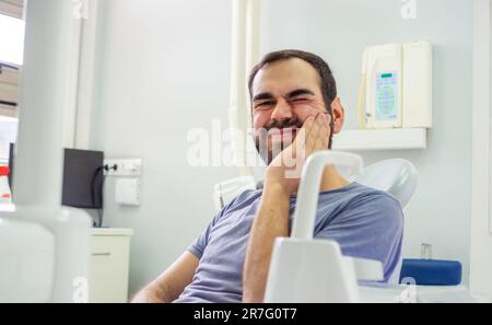 Patient having a toothache at the dentist waiting for assistance Stock Photo