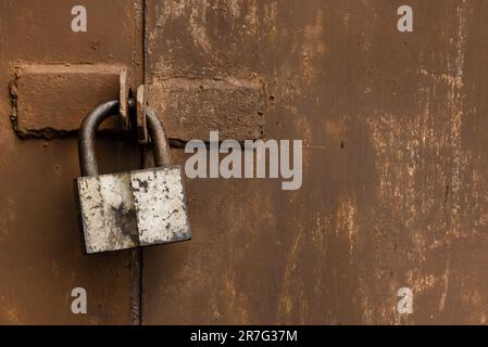 Old rusty lock on metal doors. Lock on the door with an empty place for an inscription Stock Photo