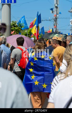 A young woman draped in the European Union flag attends Moldova's Europe day celebrations in downtown Chisinau April 21st 2023 Stock Photo