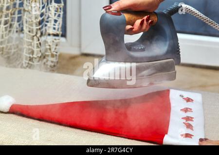 Close Woman's Hand Ironing Cloth Ironing Board Stock Photo by ©AndreyPopov  190334872