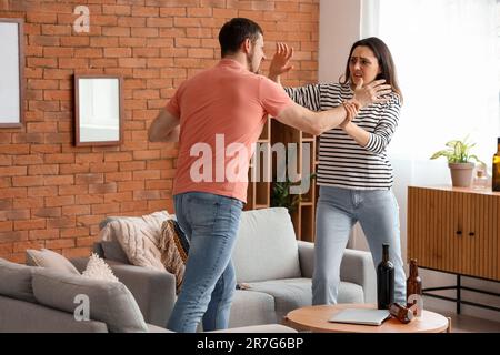 Bruised young woman with her husband fighting at home. Domestic violence concept Stock Photo