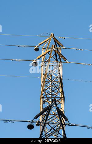 Piloncs Silhouettes of large high-voltage electricity pylons and power lines at ...