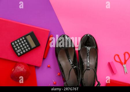 Cute school shoes with fresh apple, calculator and different stationery on color background Stock Photo