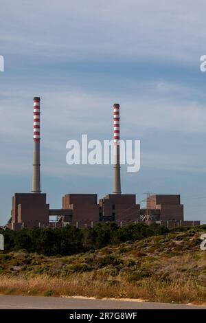 Industrial plant. Factory producing electricity with two huge chimneys Stock Photo