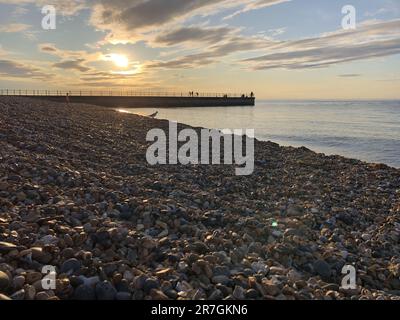Looking Across a Decorative Stack of Different Coloured Stones, Pebbles and Cobbles at Hampton Stone Beach, Hampton Pier in the Distance. Stock Photo