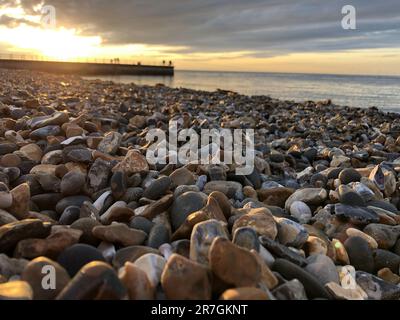 Looking Across a Decorative Stack of Different Coloured Stones, Pebbles and Cobbles at Hampton Stone Beach, Hampton Pier in the Distance. Stock Photo