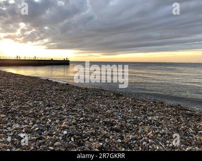 Looking Across a Decorative Stack of Different Coloured Stones, Pebbles and Cobbles at Hampton Stone Beach, Hampton Pier in the Distance. Stock Photo