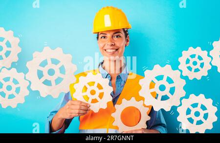 Engineer woman joins pieces of gears as concept of partnership and integration Stock Photo