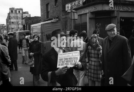 An older man a National Front supporter selling National Front News on a Sunday morning, at the north end of Brick Lane, junction with Bacon Street. Whitechapel, east London, England circa 1976.  1970s UK HOMER SYKES Stock Photo