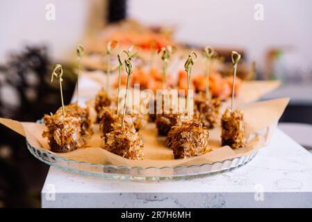 Catering food at a wedding party. Food styling and restaurant meal serving. Tuna canapes on bamboo skewers with tuna shavings. Stock Photo