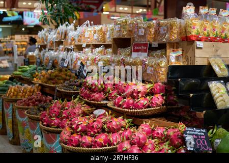 BANGKOK, THAILAND - CIRCA APRIL, 2023: various tropical fruits on display at Tops Food Hall premium-level supermarket in CentralWorld shopping center Stock Photo