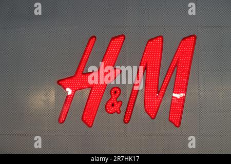 PATTAYA, THAILAND - CIRCA APRIL, 2023: close up shot of H and M sign. H and M focuses on fast-fashion clothing for men, women, teenagers, and children Stock Photo