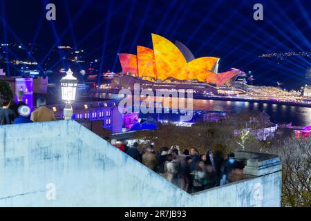 Crowds gather to witness the light show and drone display at the 2023 'Vivid Sydney' Festival in Australia. Stock Photo