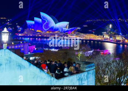 Crowds gather to witness the light show and drone display at the 2023 'Vivid Sydney' Festival in Australia. Stock Photo