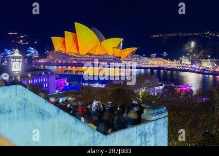 Crowds gather to witness the light show and drone display at the 2023 'Vivid Sydney' Festival in Australia. Stock Photo