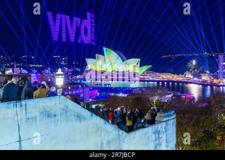 Crowds gather to witness the 'Written in the Stars' light show and drone display at the 2023 'Vivid Sydney' Festival in Sydney, Australia. Stock Photo