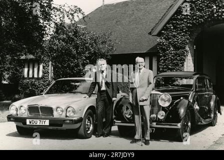 Sir William Lyons (right) founder of Jaguar with chairman John Egan with two cars, UK 1990s Stock Photo