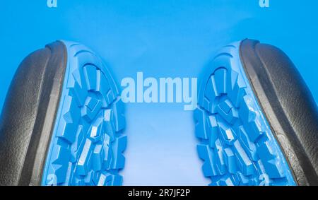 A pair of protective work shoes with blue soles for the protection of workers on a blue background Stock Photo