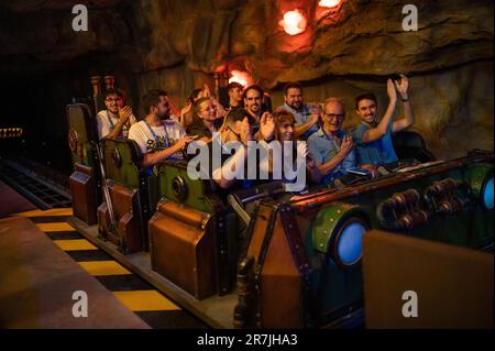 A group of people riding the new Uncharted attraction at