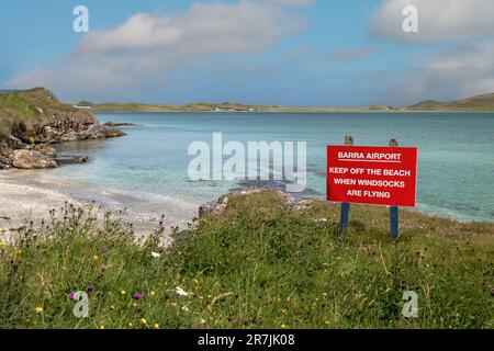 Red Warning Sign on Barra Airport on Traigh Mhor Beach at High Tide, Barra, Isle of Barra, Hebrides, Outer Hebrides, Scotland, United Kingdom Stock Photo