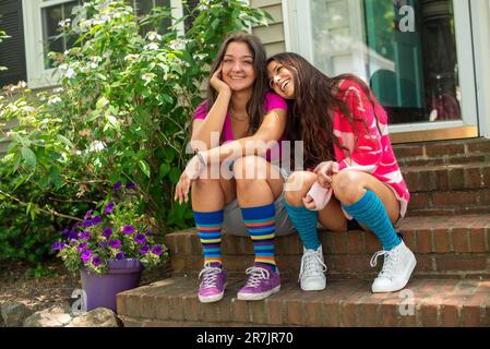 Best friends forever sitting on the  front steps Stock Photo