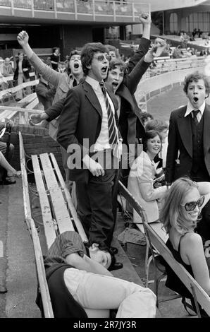 Eton v Harrow annual cricket match,  a group of excited young Harrovians cheer their own success  and jeer their  vanquished opponents, while one of their number sleeps off an afternoons excess. 1970s St Johns Wood, London, England circa June 1975. 1970s UK HOMER SYKES Stock Photo