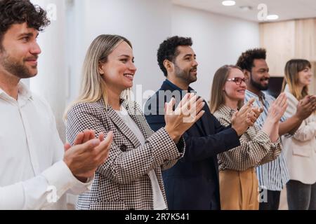 Happy business people clapping hands after a presentation in office Stock Photo