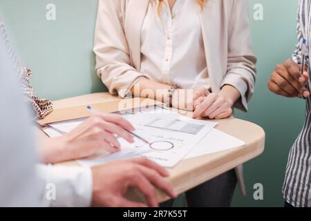 Close-up of business colleagues discussing plan in office Stock Photo