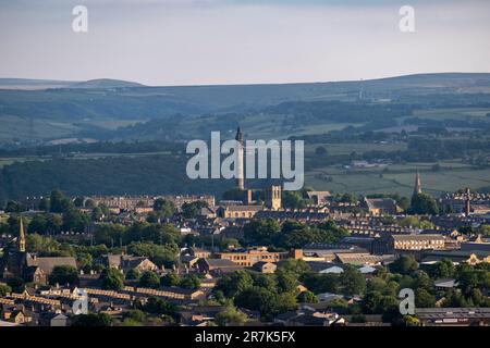 Elevated view looking over the town centre from and towards the surrounding countryside on 7th June 2023 in Halifax, United Kingdom. Halifax is a town in the borough of Calderdale in West Yorkshire and was a thriving mill town during the industrial revolution. Nowadays, while the town is showing positive signs of regeneration in some areas, the economic downturn in the UK and other recent factors has resulted in signs of a once prosperous town currently struggling economically. Stock Photo