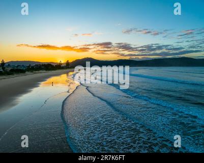 Sunrise with scattered clouds and small waves at Ocean Beach in Umina Beach on the Central Coast, NSW, Australia. Stock Photo