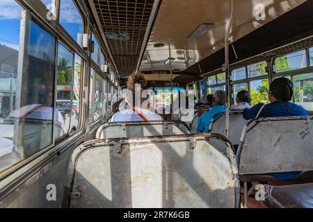 Nadi, Fiji - 23 May 2023: Indigenous Fijian people travel by bus. In Fiji every town and village has a bus stop since this is still the most common fo Stock Photo