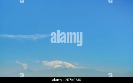 Mount Ararat is located in Turkish territory with a view from the territory of Armenia from Yerevan on a bright sunny day, a long wide banner Stock Photo