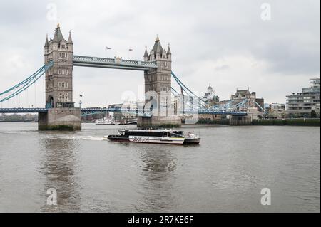 Uber Sponsored Thames Clipper boat in front of Tower Bridge in East London, London, England Stock Photo
