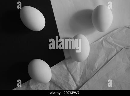 flat lay of four eggs in classical 1920's style, black and white shot with free copy space Stock Photo