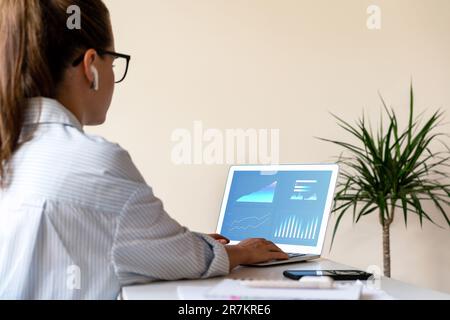 Sales manager woman analysing commercial kpis, graphs and charts of business performance on laptop screen. Stock Photo