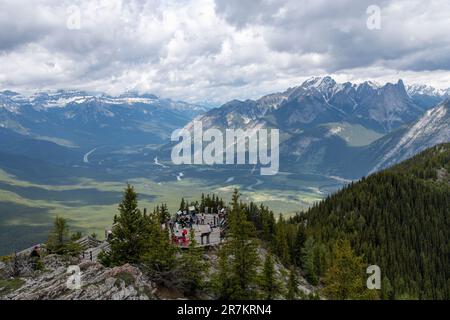 Banff, AB, Canada-August 2022; High angle panoramic view from top of Sulphur Mountain, with people on viewing platform and view on valley with Bow Riv Stock Photo