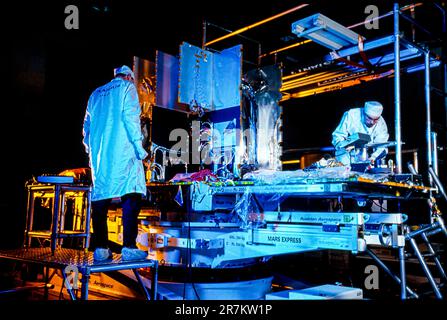 Mars Express spacecraft construction - Mars Express spacecraft construction. Engineer working on the engines of the Mars Express spacecraft during the spacecraft's construction in the clean room at the Alenia Spazio company, Turin, Italy. This is a European Space Agency (ESA) unmanned probe that was approved for construction in January 2000, launched in June 2003, and reached Mars in December 2003. Its instruments are being used to map Mars and analyse the composition of the planet's surface. The initial Mars Express mission, which was for one Martian year (687 Earth days), is still continuing Stock Photo
