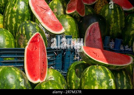 Sliced and whole watermelons sold in the market Stock Photo