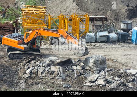Aerial view Hydraulic scissors on rigging to cut abandoned buildings destroy building, Hydraulic scissors on rig of crane cut building on construction Stock Photo