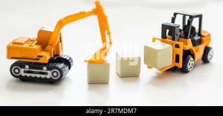 Toy bulldozer hold letter block  Stock Photo