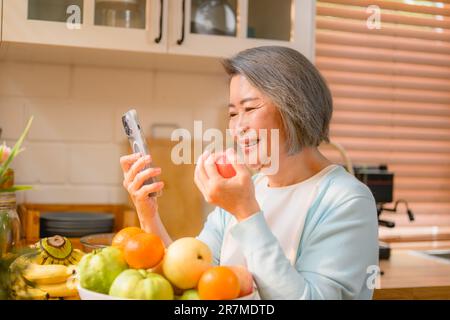 senior portrait. cheerful senior smiling portrait. mature woman using phone. Stock Photo