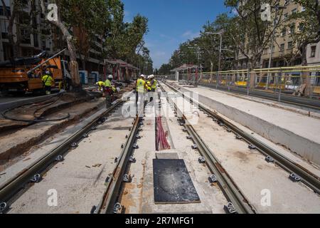 Operators are seen working on the new sections of electrified tracks deployed on Avenida Diagonal. Redevelopment of tram in Avenida Diagonal which will reduce traffic in public and also generate new space for pedestrians and bicycle users. Stock Photo