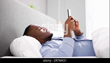 African Man Holding Smartphone Or Mobile Phone Stock Photo