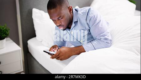 African Man Holding Smartphone Or Mobile Phone Stock Photo