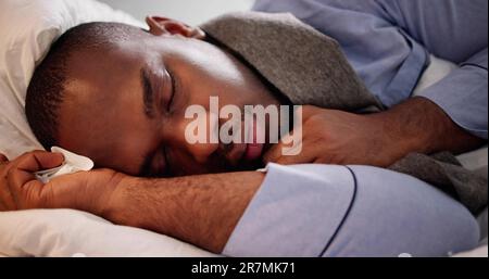 Sick Man Sleeping In Bed To Rest Stock Photo