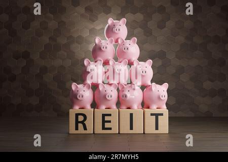 Heap of pink piggy banks on wooden blocks written with the alphabet REIT. Illustration of the concept of real estate investment trust Stock Photo
