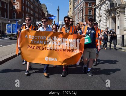 London, UK. 16th June 2023. Junior doctors march through Whitehall as their strike over pay restoration continues. Stock Photo