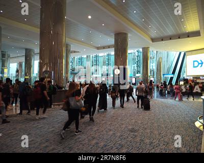 dubai international airport transit,Dubai airport,airport transit,passengers in transit,connection flight,asian passenger,UAE,shopping in dubai airpor Stock Photo