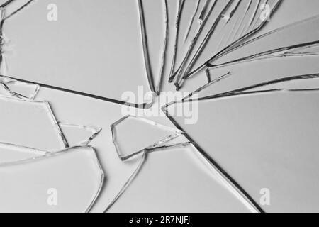 Broken glass pile pieces of texture and background isolated on white, cracked window effect. Emergency condition Stock Photo