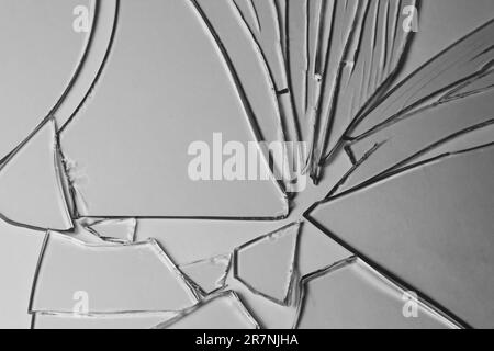 Broken glass pile pieces of texture and background isolated on white, cracked window effect. Emergency condition Stock Photo